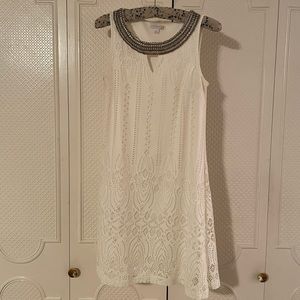 White lace sleeveless dress with breaded neckline. Size 6